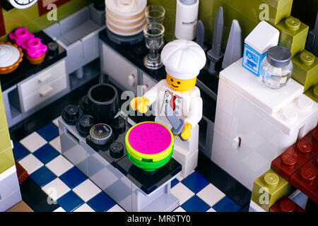 Tambov, Russian Federation - January 04, 2018 Lego chef cutting watermelon in his kitchen. Studio shot. Stock Photo