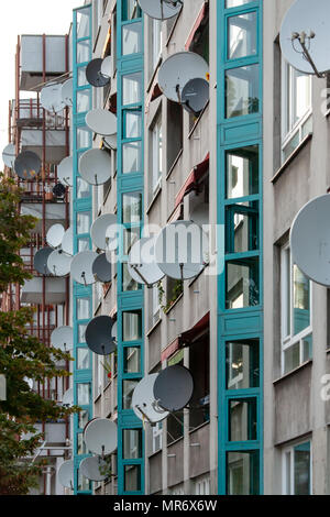 Numerous satellite television dishes attached to a multi-storey residential building in Berlin Stock Photo