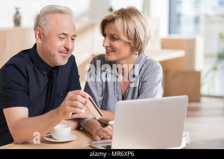 affectionate couple wanting to buy something online and pay with credit card Stock Photo