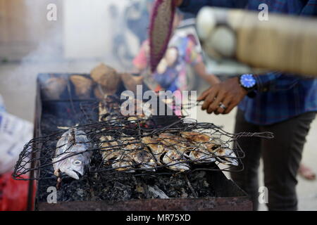 Food vendor cooks and sells Barbecue Grill fish at the street market in Banda Aceh City Stock Photo