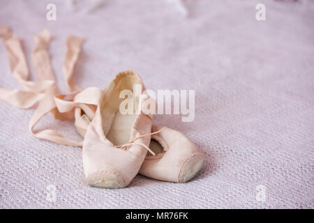 Small ballet shoes isolated on pink background