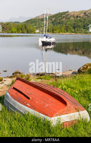 An upturned rowing boat on the side of Lake Windermere near Holme Crag Stock Photo
