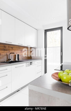 White kitchen with island in new luxury home Stock Photo
