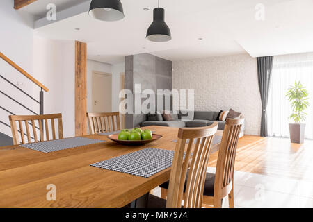 Dining room with communal table open to living room Stock Photo