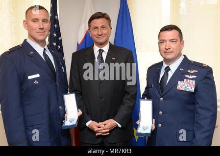 Major Jeffrey Canett (left) of the 102nd and Major Edward 'Sean' Boughal (right) of the 103rd Rescue Squadrons of the 106th Rescue Wing assigned to the New York Air National Guard, are awarded the Slovenian Medal for Merit in the military field by the President Borut Pahor of Slovenia May 21, 2017. The ceremony took place at the Permanent Mission of the Republic of Slovenia office to the United Nations, New York for their international rescue mission to render aid to crew members injured in an explosion on board the motor vessel Tamar that began on April 24th. (U.S. Air National Guard Photo by Stock Photo