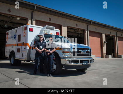 Arin Meyer, a 49th Medical Operations Squadron emergency medical technician-Basic, and Jillian Barker, a 49th MDOS paramedic, pose for a photo outside the fire station for National Emergency Medical Services week at Holloman Air Force Base, N.M. on May 17, 2017. National EMS week was established in 1974, as a means to honor EMS practitioners and their contributions to families and communities across the United States. Licensing to become an emergency medical technician requires formal training at the EMT-Basic, EMT-Intermediate or EMT-Paramedic level. Training programs are offered at emergency Stock Photo