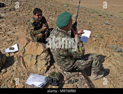 Afghan Air Force members communicates on the ground with an A-29 Super Tucano pilot over radio communications near Logar Province, Afghanistan, May 21, 2017. Train, Advise, Assist Command-Air (TAAC-Air) advisors, held a live-fire training exercise for a class of Afghan Tactical Air Coordinators. Prior to the exercise, advisors from TAAC-Air conducted three weeks of classroom training. The live fire exercise is part of a practical evaluation before Afghan Air Force personnel can graduate as ATACs. (U.S. Air Force photos by Tech. Sgt. Veronica Pierce)