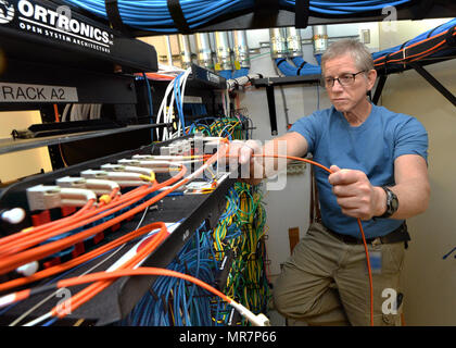 88th Communications Squadron is a United States Air Force unit stationed at Wright-Patterson Air Force Base, Ohio. On May 10, 2017, a cable systems maintenance technician prepared fiber optic cable for attachment to computer servers as part of installation network operations. The archival image records communications infrastructure support performed on base. Stock Photo