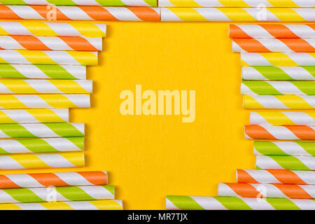 close-up colorful fancy drinking straws, fancy tube for party on the yellow background Stock Photo