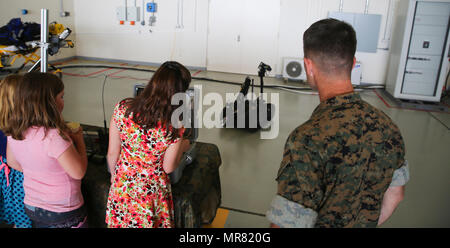 Master Sgt. David Bill, explosive ordnance disposal platoon staff noncommissioned officer in charge with Special Purpose Marine Air-Ground Task Force – Crisis Response – Africa, observes service members and their families utilize the MTRS Talon prior to President Donald Trump’s speech at Naval Air Station Sigonella, Italy, May 27, 2017. Trump traveled to Sicily in order to attend the G7 Summit and meet with other world leaders, to include Italian Prime Minister Paolo Gentiloni. NASSIG is a strategically located base capable of supporting an array of operations which houses sailors, airmen, sol Stock Photo