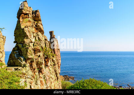 Rock formations on the coast of Hovs Hallar in the Bjare coast nature reserve, outside Bastad, Sweden. A sunny morning with calm sea. Stock Photo