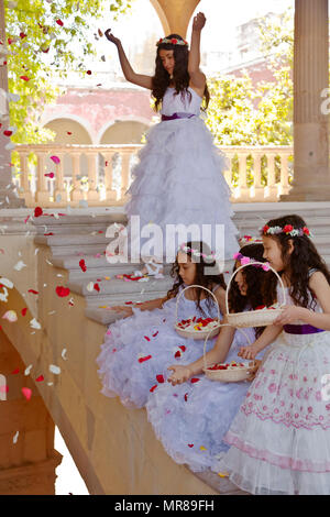 Young Mexican girls dressed in their Easter best throw rose petals at Jaral de Berrio - SAN FELIPE, MEXICO Stock Photo