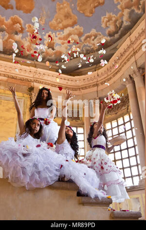 Young Mexican girls dressed in their Easter best throw rose petals at Jaral de Berrio - SAN FELIPE, MEXICO Stock Photo