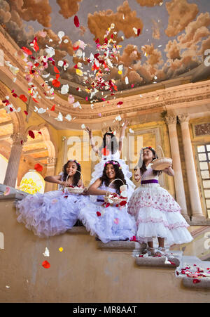 Young Mexican girls dressed in their Easter best throw rose petals at Jaral de Berrio - SAN FELIPE, MEXICO Stock Photo