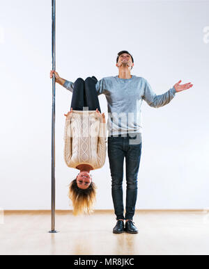 Young man and woman pole dancers in casual clothing happy emotions Stock Photo