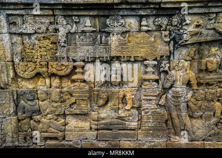 relief panels on the 4th balustrade of 9th century Borobudur Buddhist temple, the approximately 2672 panels form one of the most comprehensive Buddhis Stock Photo