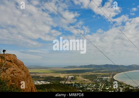 Man taking photograph of Townsville and magnetic island from Castle Hill, Castle Hill QLD 4810, Australia Stock Photo