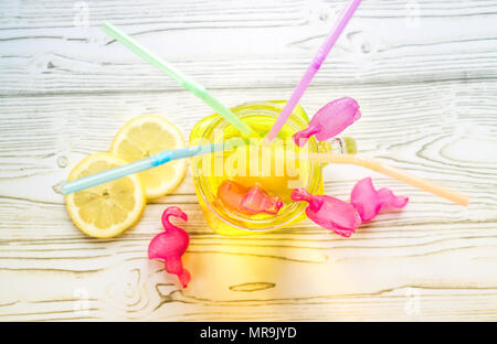 Ice cold Lemonade in glass jar with straws and icy plastic flamingos Stock Photo