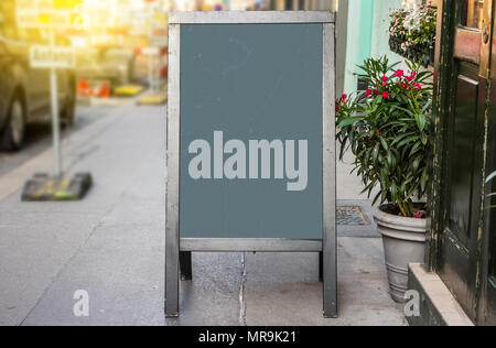 Wooden rustic blackboard in front of restaurant entrance Stock Photo