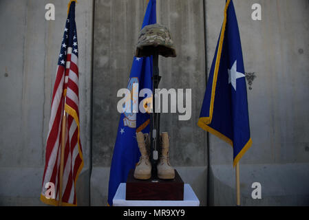 A Battlefield Cross is displayed during a Memorial Day ceremony at Bagram Airfield, Afghanistan, May 29, 2017. The boots, rifle and helmet make what is called the Battlefield Cross, which is a symbolic replacement of a cross and is used to honor and show respect to deceased service members. (U.S. Air Force photo by Staff Sgt. Benjamin Gonsier) Stock Photo