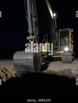 Staff Sgt. Sean O’Connor, 31st Expeditionary Rapid Engineer Deployable Heavy Operational Repair Squadron Engineers water fuels maintenance craftsmen, operates an excavator to move dirt and debris from a trench at Nigerien Air Base 201, Niger, May 9, 2017. The trench will house part of the water line that will support a living area for Airmen deployed to the 724th Expeditionary Air Base Squadron. (U.S. Air Force photo by Senior Airman Jimmie D. Pike) Stock Photo
