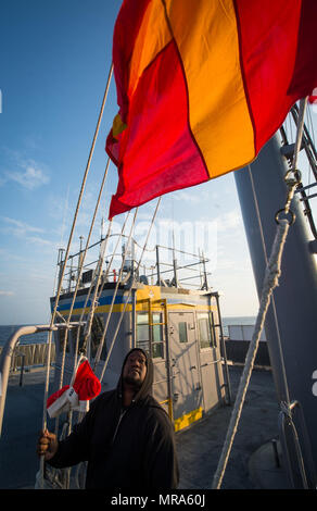 Unrep Flags This image shows a Navy signal crew on a submarine using a floodlight ...
