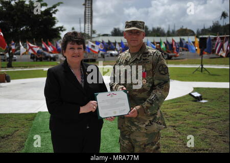 Ms. Brenda Lee McCullough presents Col. Michael T. Harvey with a legion of merit for his outstanding service as U.S. Army Fort Buchanan Garrison Commander during a change of command ceremony held at Soldiers Plaza on Fort Buchanan, May 31. Stock Photo