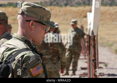 U.S. Army Spc. Justin Carter, assigned to the 311th Signal Command, 275th Signal Company, examines his shot group during range familiarization at Fort Huachuca, Az., May 12, 2017. Carter participated in range familiarization to prepare himself for the 2017 Network Enterprise Technology Command Best Warrior Competition. (U.S. Army photo by Spc. Quince C. Lanford) Stock Photo