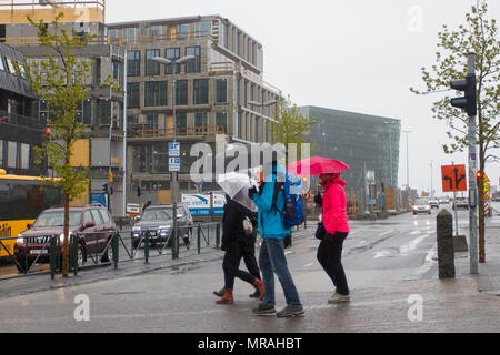 Laugavegur, Reykjavík, Iceland. 26/05/2018. Yellow warning for bad weather on the island as tourists from cruise ships and foreign holidaymakers visit the shops, in the tourist section of the city centre. A day of windy, persistent continuing heavy rain is forecast. Credit: MediaWorldImages/AlamyLiveNews. Stock Photo