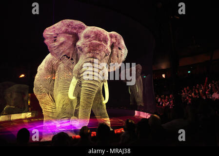 25 May 2018, Germany, Duesseldorf: Elephant holograms floating through the ring at the evening of the premiere of the 'Circus Roncalli' at the Rheinpark with the programme 'Storyteller: Yesterday-Today-Tomorrow'. Clowns, magicians and performers will be able to enthrall circus lovers from 25 May until 24 July 2018. However, animals such as horses, elephants and fish will only participate as holograms. Photo: Horst Ossinger//dpa Stock Photo