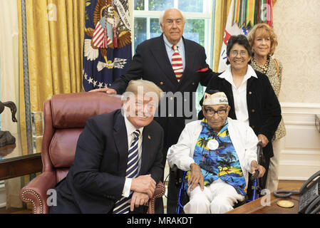 WASHINGTON, DC - WEEK OF MAY 21: President Donald J. Trump welcomes 106-year-old Pearl Harbor veteran Ray Chavez of Poway, CA, to the Oval Office at the White House, Thursday, May 24, 2018, in Washington, D.C. Chavez, the oldest living Pearl Harbor veteran, is joined by his daughter, Kathleen Chavez, wearing a dark jacket, and friends and caretakers Richard and Jeris Rovsek  People:  President Donald Trump Stock Photo