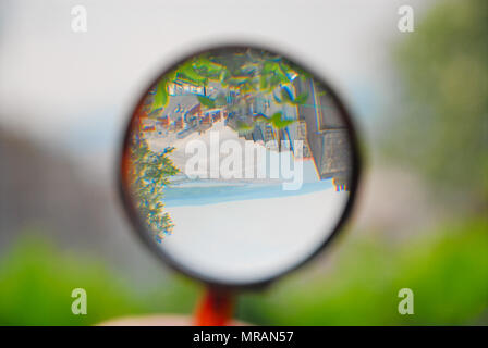 Portland. 26 May 2018. The shape of sunny Chesil Beach still looks familiar when inverted by a magnifying glass Credit: stuart fretwell/Alamy Live News Stock Photo