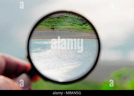 Portland. 26 May 2018. Even when inverted by a 'Sherlock style' magnifying glass,  sunny and sparkling Lyme Bay always looks enticing Credit: stuart fretwell/Alamy Live News Stock Photo