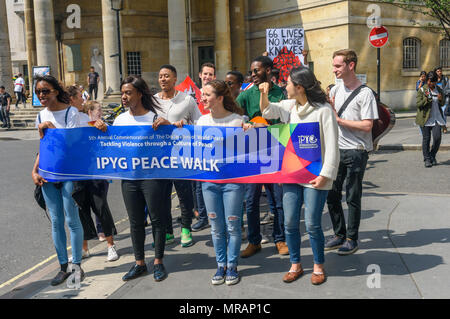 London, UK. 26 May 2018. The IYPG (International Peace Youth Group) have held annual peace walks in countries around the world on or around May 25th since 2013, commemorating the 'Declaration of World Peace'. This year the London walk included a poster about knife crime in London. Credit: Peter Marshall/Alamy Live News Stock Photo