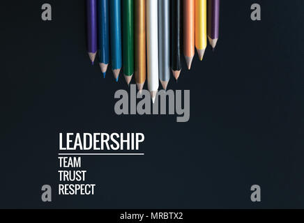 Leadership business concept. white color pencil lead other color with word Leadership, team, trust and respect on black background Stock Photo