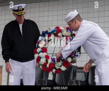 170602-N-KH214-106 OAK HARBOR, Wash. (June 2, 2017) Capt. Geoffrey Moore, commanding officer, Naval Air Station Whidbey Island (NASWI), and Master-at-Arms 3rd Class Killian Ferrel, assigned to NASWI, prepare the ceremonial wreath during the annual commemoration ceremony for the Battle of Midway at the PBY-Naval Air Museum's Catalina aircraft. NASWI and the PBY-Naval Air Museum hosted the 75th anniversary of the renowned World War II battle to honor those who served and died during the war. (U.S. Navy photo by Mass Communication Specialist 2nd Class Scott Wood/Released) Stock Photo