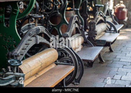 Old mangle for housework. Devices that facilitate housework in an old house. Season of the spring. Stock Photo