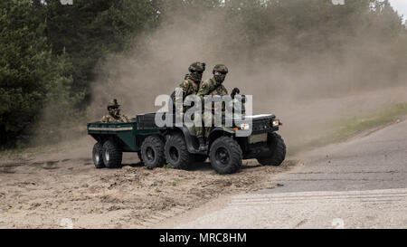 SALASPILS, Latvia-Soldiers of the Norwegian Armed Forces drive through training areas surrounding Camp Adazi, Latvia, during preparation for Exercise Saber Strike 17, June 2, 2017.  Exercise Saber Strike 17 is an annual combined-joint exercise conducted at various locations throughout the Baltic region and Poland. The combined training prepares NATO Allies and partners to effectively respond to regional crises and to meet their own security needs by strengthening their borders and countering threats. (U.S. Marine Corps photo by Cpl. Devan Alonzo Barnett/Released) Stock Photo