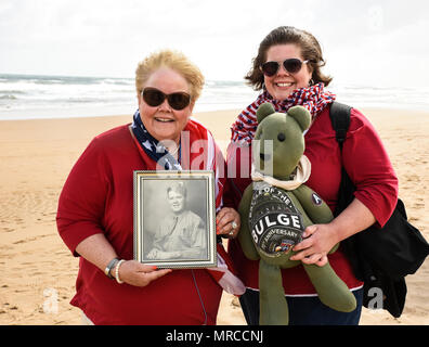 Connie French Rinker, the daughter of World War II veteran Cpl. Cornelius T. French, Jr, picture shown, poses for a picture with her daughter Erin-Caitlin Rinker, June 6, 2017, on Omaha Beach in Saint-Laurent-sur-Mer, France. Cpl. French served as a gunner with Charlie Company, 37th Tank Battalion, 4th Armored Division, during World War II. This ceremony commemorates the 73rd anniversary of D-Day, the largest multi-national amphibious landing and operational military airdrop in history, and highlights the U.S.’ steadfast commitment to European allies and partners. Overall, approximately 400 U. Stock Photo