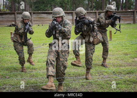 U.S. Marine Corps recruits with Papa and Delta Company, Recruit Training Regiment, move to their next obstacle during Basic Warrior Training on Marine Corps Recruit Depot, Parris Island, S.C. on June 6, 2017. Basic Warrior Training is designed to teach the importance of teamwork, working under stress and how to perform while utilizing small unit leadership. (U.S. Marine Corps photo by Cpl. Richard Currier/Released) Stock Photo