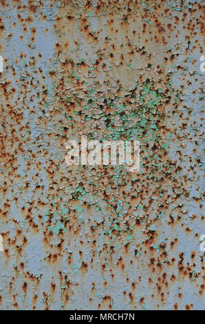 Rusty metal texture with scratched surface. Old painted metal wall with peeling paint. Texture obsolete painting metal fence close-up Stock Photo