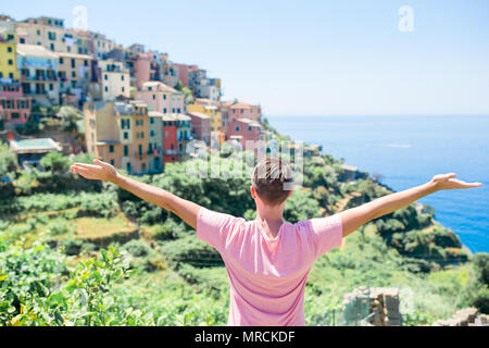 Tourist looking at scenic view of Manarola, Cinque Terre, Liguria, Italy Stock Photo