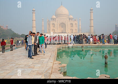 Agra, India - November 29, 2015: Famous Taj Mahal with visiting tourists - an immense mausoleum of white marble built by the Mughal emperor Shah Jahan Stock Photo