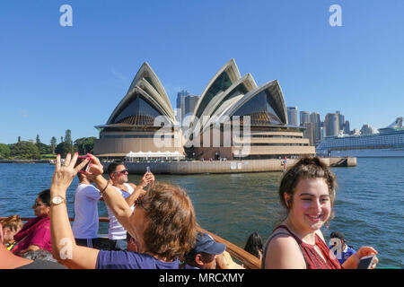 Sydney, Australia: March26, 2017: Tourists take photographs in Sydney Harbour as they leave the wharf on the Manly Ferry. Stock Photo