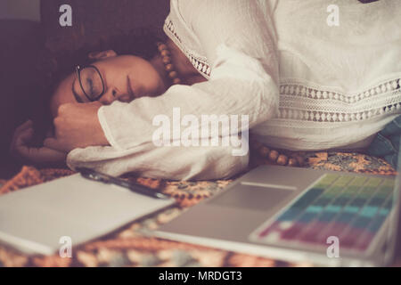 lonely beautiful caucasian woman sleep after a strong hard work at home with laptop. no hours problem working at home instead that an usual office. al Stock Photo