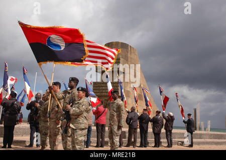 Soldiers of the 29th Infantry Division Color Guard, participate in a ceremony honoring World War II veterans held at the Omaha Beach memorial in St. Laurent-Sur-Mer,, France, June 6, 2017. The ceremony commemorates the 73rd anniversary of D-Day, the largest multi-national amphibious landing and operational military airdrop in history, and highlights the U.S.' steadfast commitment to European allies and partners. Overall, approximately 400 U.S. service members from units in Europe and the U.S. are participating in ceremonial D-Day events from May 31 to June 7, 2017. (U.S. Army Photo by Master S Stock Photo