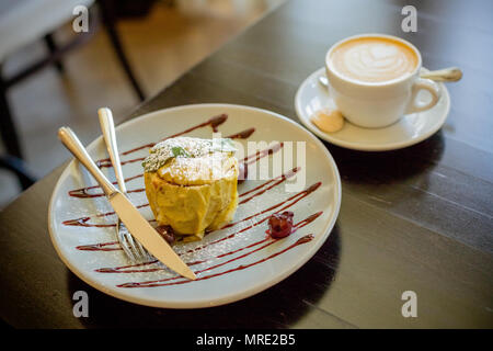 Baked apples with cottage cheese,nuts, raisins and coffee cup.Apple with latte art coffee on the table.breakfast dessert.good morning.Healthy fruit dessert. Baked apples with granola, cinnamon, nuts and honey. Vegetarian food. Stock Photo