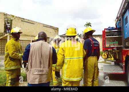 170610-N-CM227-034 Fire officers from the Bridgetown Fire Department assess and assist a volunteer actor during a mass casualty drill at the site of the former Glendairy Prison. The scenario was based on the idea that an earthquake caused a hotel to collapse and local emergency services and Barbados Defence Force (BDF) personnel were working together to rescue and treat survivors. Tradewinds 2017 Regional Observer and Assessment Team (ROAT) members from multiple countries watched the exercise to take notes and create an assessment for Barbadian officials. The report will contain ideas of ways  Stock Photo