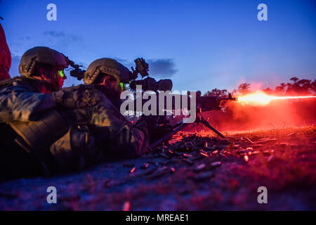 Marine Special Operations School Individual Training Course students fire an M249 squad automatic weapon during night-fire training April 13, 2017, at Camp Lejeune. For the first time, U.S. Air Force Special Tactics Airmen spent three months in Marine Special Operations Command’s initial Marine Raider training pipeline, representing efforts to build joint mindsets across special operations forces.  (U.S. Air Force photo by Senior Airman Ryan Conroy) Stock Photo