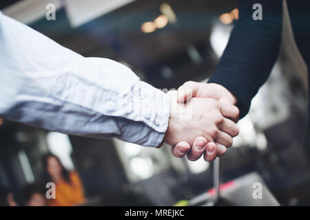Two business partners shake hands after a successful deal. Close up view of business partnership handshake Stock Photo